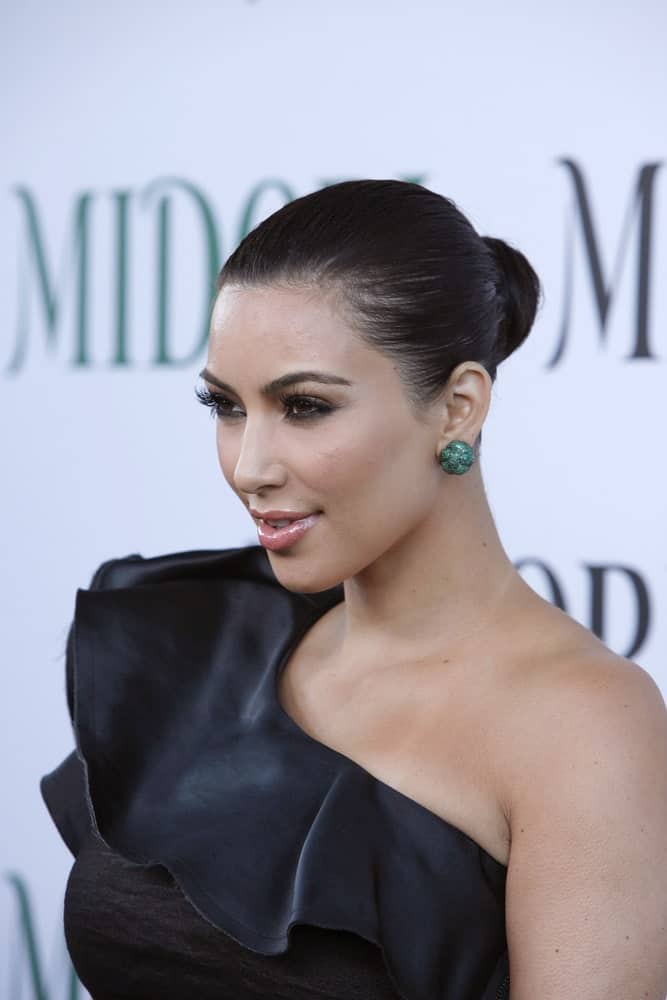 Kim Kardashian matched her black one-shoulder dress with a neat bun at the Midori Melon Liqueur Trunk Show at Trousdale on May 10, 2011.