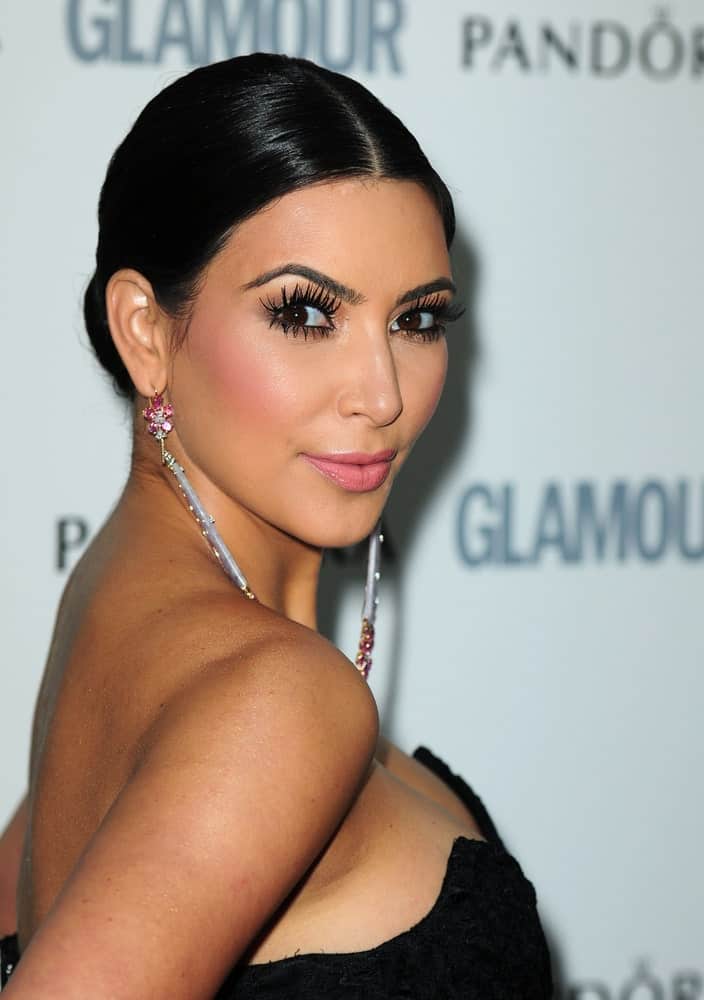 Kim Kardashian looked classy in a neat updo that's paired with gorgeous dangling earrings and a black dress at the 2011 Glamour Awards on July 6, 2011, in Berkeley Square, London.
