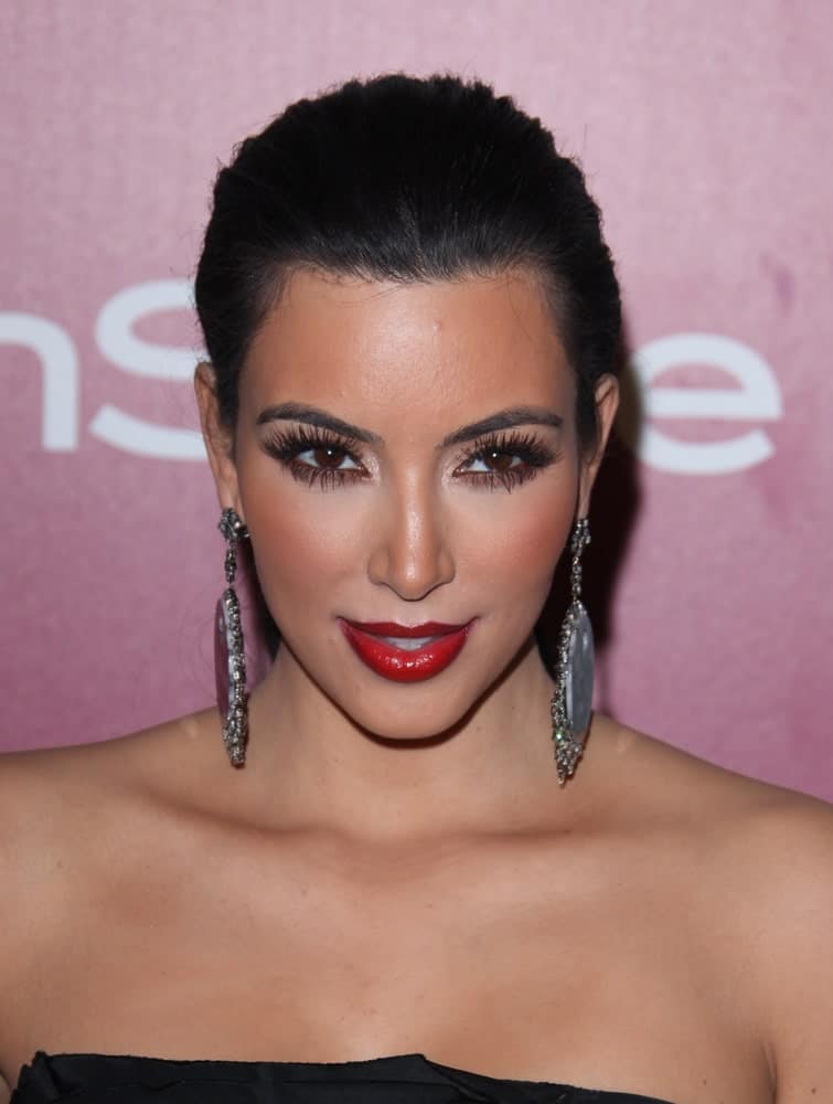 Kim Kardashian rocked a neat updo emphasizing her dangling earrings at the 12th Annual WB-In Style Golden Globe After Party on January 16, 2011.