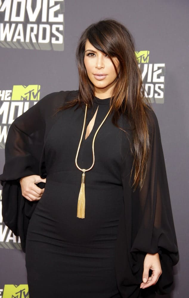 Kim Kardashian with her long tousled layered hair accentuated with brown highlights during the Movie Awards held at the Sony Pictures Studios in Culver City, CA on April 14, 2013.