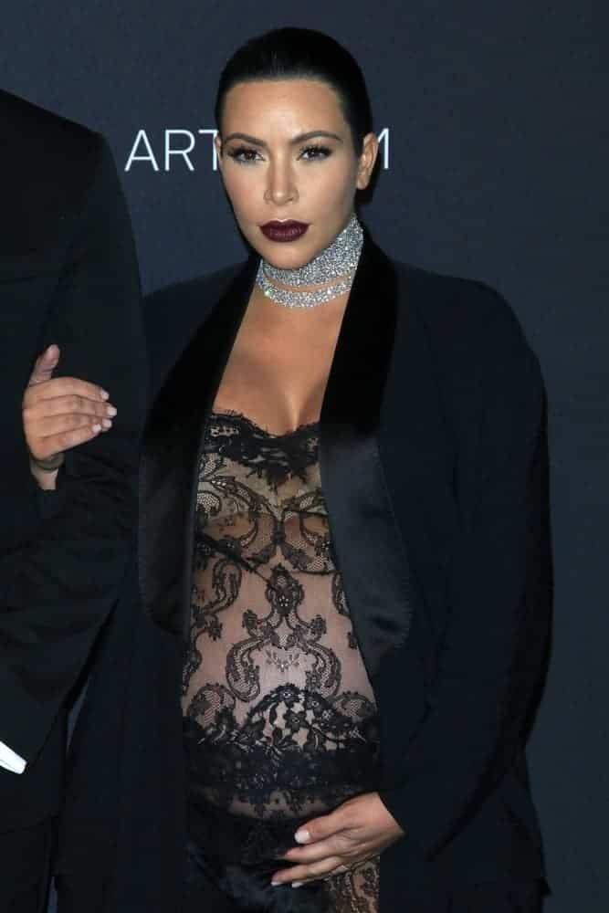 Pregnant Kim Kardashian pulled off a sexy and revealing see-through black lace jumpsuit and completed the look with a long, sleek fishtail braid hairstyle at the LACMA Art + Film Gala.