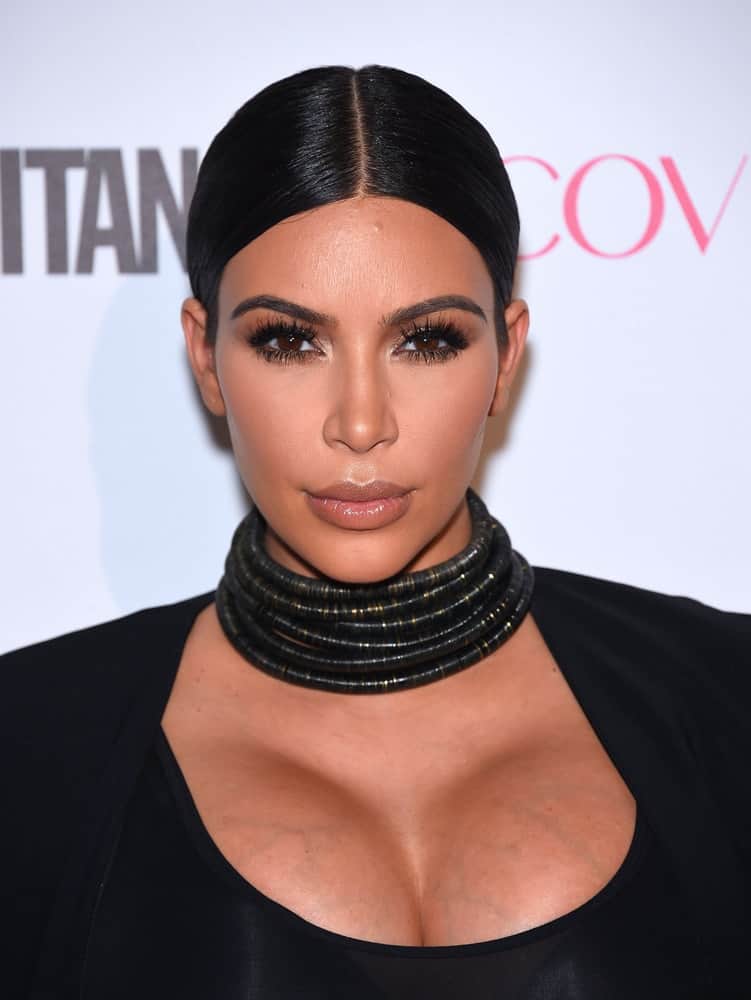 Pregnant Kim Kardashian rocked in a skintight black dress and picked the black coil choker as a statement, as she wore her hair parted down the middle and back in a low ponytail at the Cosmopolitan's 50th Birthday Party in Hollywood, CA.