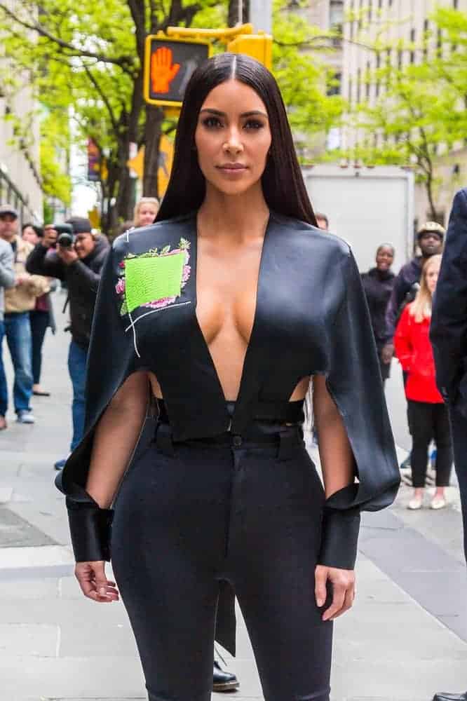 Kim Kardashian was seen in a glamorous long straight hairstyle with a center parting together with her very stylish cape-like top and black Balenciaga pants at the 2017 NBCUniversal Upfront event.