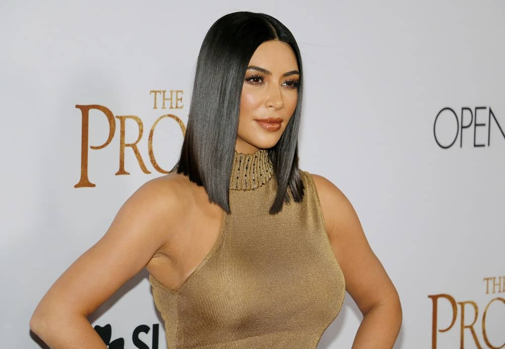 Kim Kardashian stuns in a skintight gold dress and wore her bob hair straight with a middle part just like an Egyptian Queen as she attends the Los Angeles premiere of 'The Promise'.