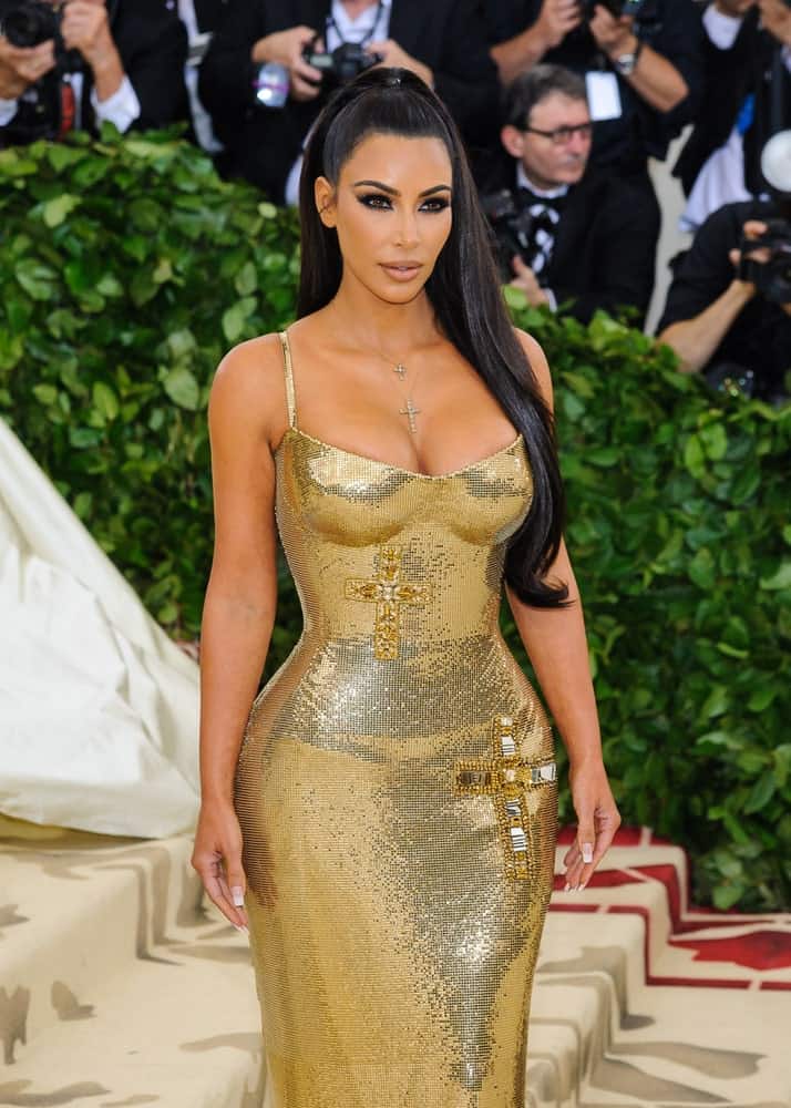 Kim Kardashian arrived for the 2018 Metropolitan Museum of Art Costume Institute Gala: "Heavenly Bodies: Fashion and the Catholic Imagination" on May 7, 2018 with a sky-high ponytail complemented with a stunning gold gown.