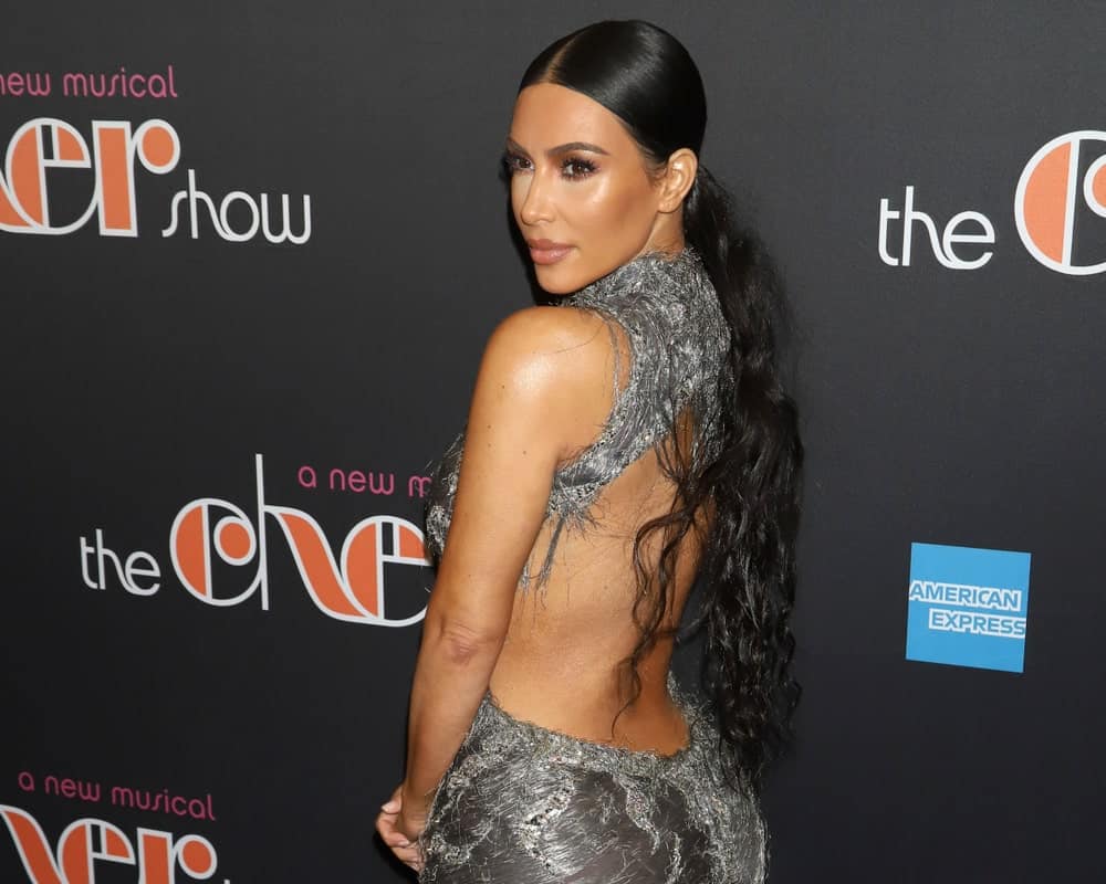 Kim Kardashian wore a sexy backless gown that goes along her long curly ponytail at the Broadway opening night of "The Cher Show" on December 3, 2018.