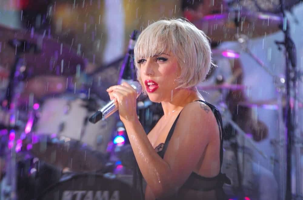 Lady Gaga was on stage for NBC Today Show Concert with Lady Gaga in Rockefeller Plaza, New York on July 9, 2010. Despite the rain, she looked lovely with her bold red lips and matching short platinum blond hairstyle with blunt bangs.