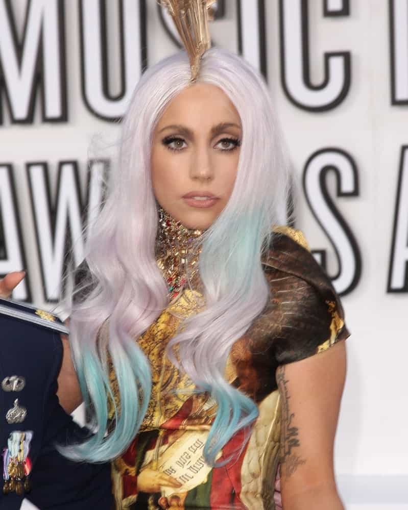 Lady GaGa attended the 2010 MTV Video Music Awards in Los Angeles, CA on September 12, 2010. She wore a colorful and artistic dress that complemented her pale platinum blond hairstyle with wavy blue dyed tips.