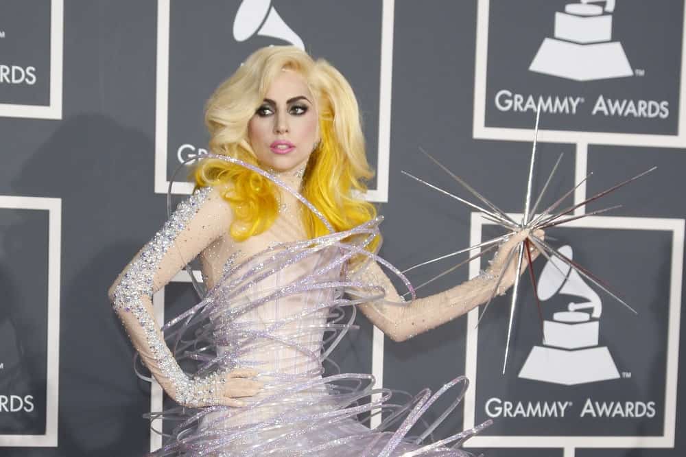 Lady Gaga was at the 52nd Grammy Awards at Staples Center in Los Angeles, California on January 31, 2010. She wore a star-themed artistic dress that complemented her loose and tousled blond hair with yellow dye at the tips.