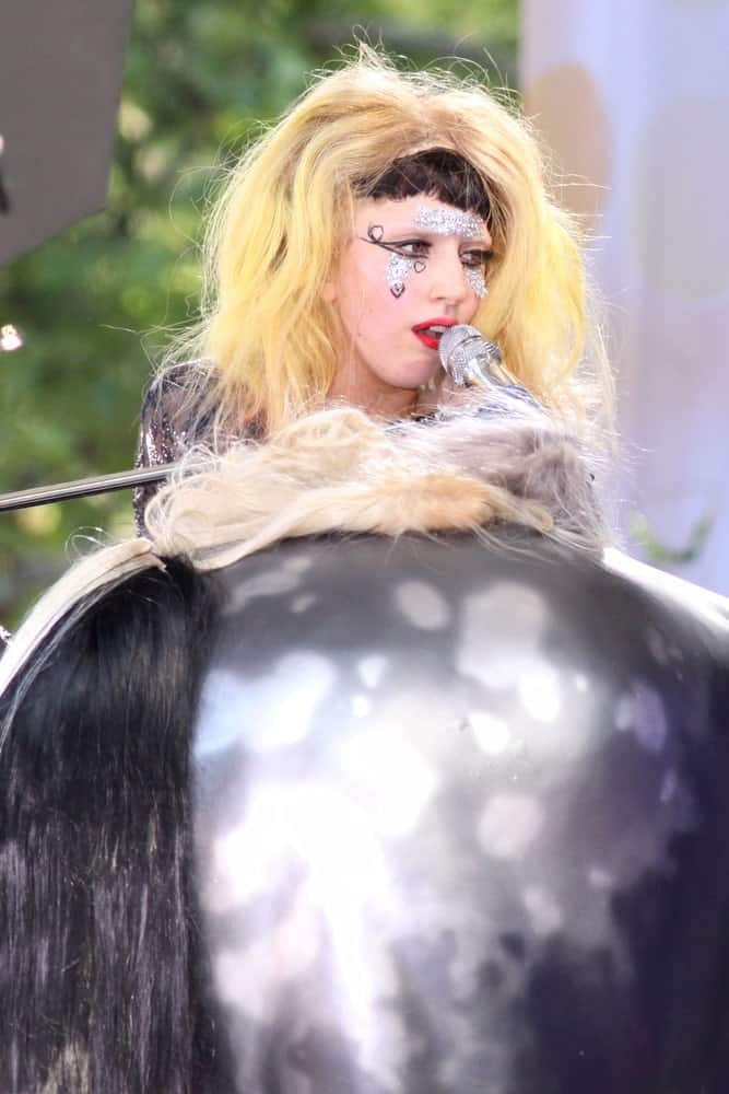 Lady Gaga performed on 'Good Morning America's' concert series in Central Park on May 27, 2011 in New York City. She was seen wearing a shoulder-length tousled blond hair with short black blunt bangs.