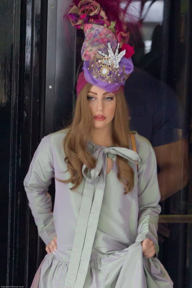 Lady Gaga was seen leaving the Dorchester Hotel on September 10, 2012 in London, UK. She was wearing a long gray gown to pair with her tall headdress and straight curtain brown hair with vintage curls at the tips.