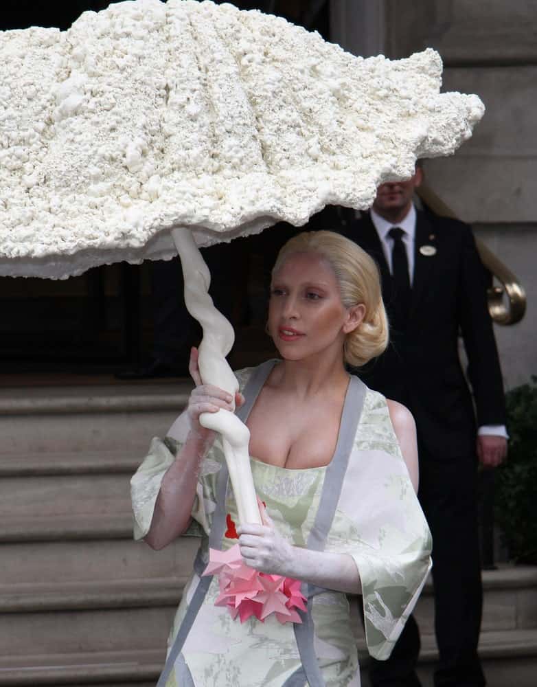 Lady Gaga was seen leaving her hotel on October 31, 2013 in London. She caught the attention of everyone with her unique umbrella, fashionable kimono-like outfit and brushed back blond hair with vintage curls at the tip.