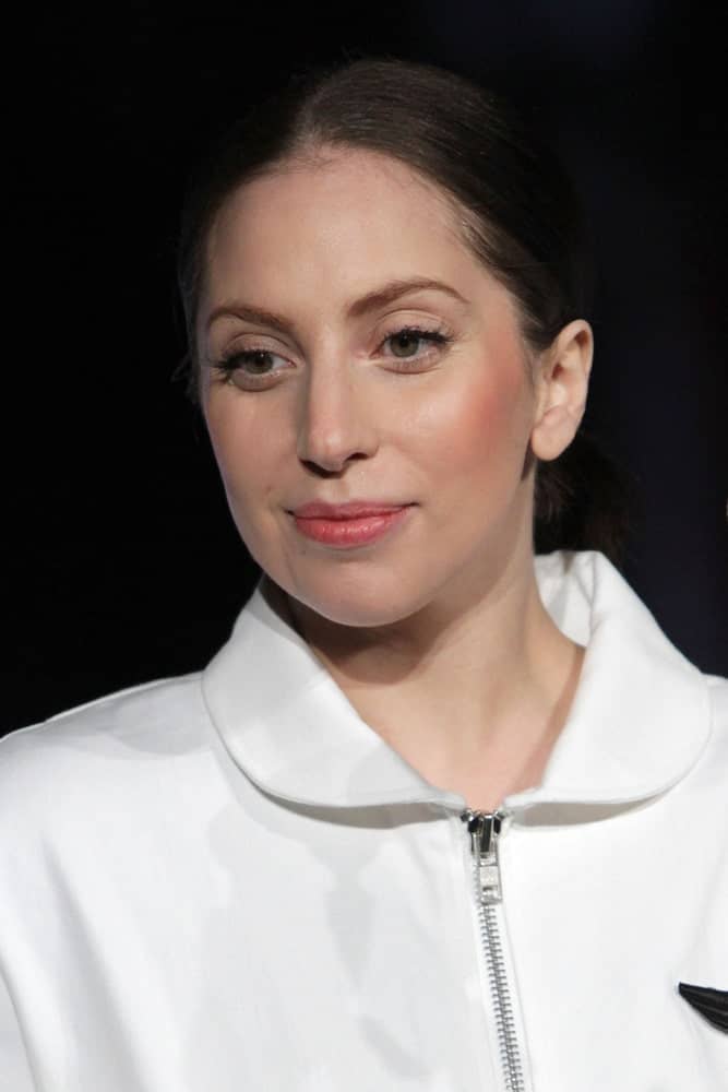 Lady Gaga went for a simple look on her white jacket, simple make-up and low ponytail to her dark brown hair when she attended the record release party event for 'ARTPOP' at the Brooklyn Navy Yard on November 10, 2013 in New York.