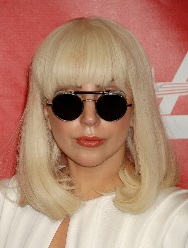 Lady Gaga went with a classy shoulder-length bob hairstyle that has blunt bangs to go with her white dress at the 2014 MusiCares Person Of The Year Honoring Carole King on January 24, 2014 in Los Angeles, CA.