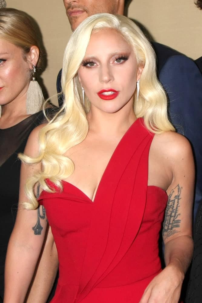Lady Gaga channeled a little bit of Jessica Rabbit with her lovely red dress, red lips and alluring long wavy side-swept blond hair at the "American Horror Story: Hotel" Premiere Screening at the Regal 14 Theaters on October 3, 2015 in Los Angeles, CA.