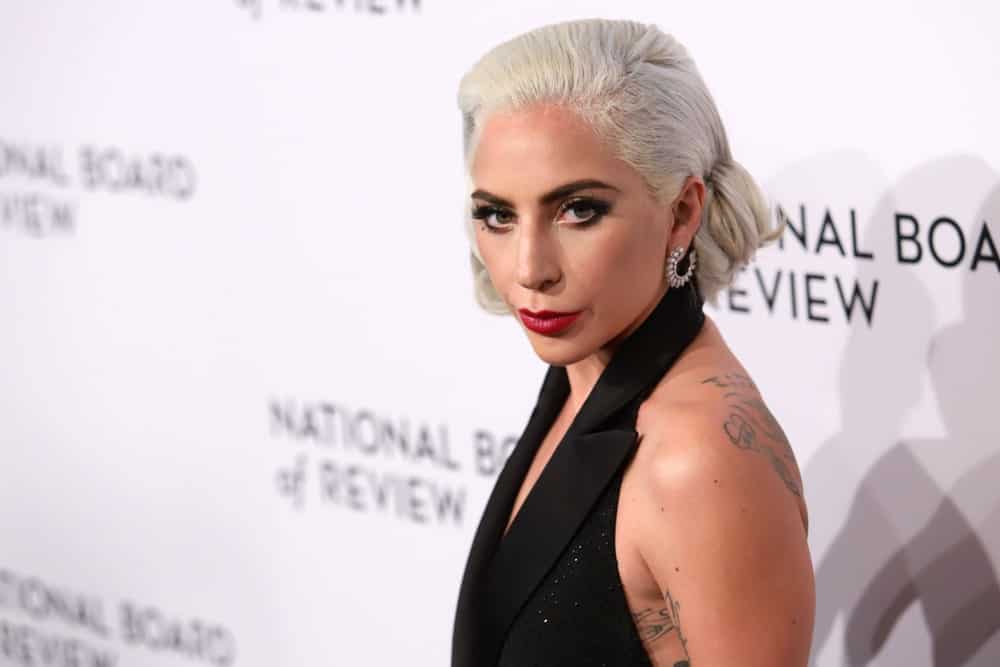 Lady Gaga's white blond hair was styled into a classy side-parted low bun when she attended the National Board of Review Awards at Cipriani on January 8, 2019 in New York.