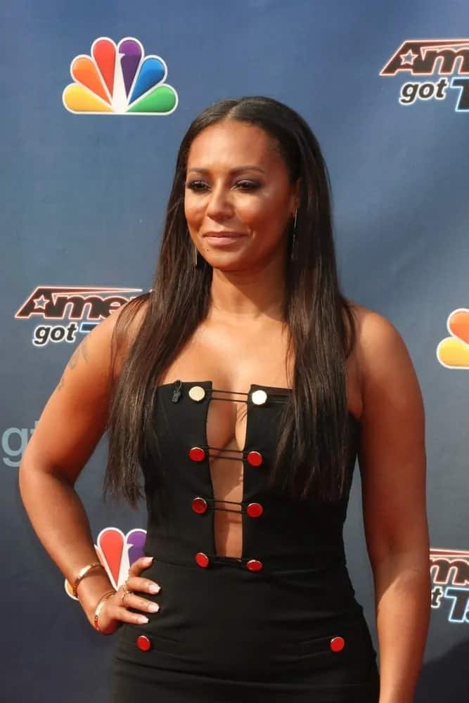 Mel B highlighted her slender physique in a black dress with a cleavage-showing front cutout and had her long straight dark hair down to complete her eye-catching look at the America's Got Talent Judges Photocall on March 3, 2016.