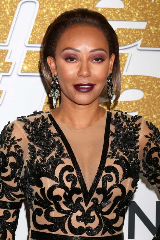 Mel B arrived at the "America's Got Talent" Season 13 Live Show Red Carpet on August 14, 2018, with a slicked bob. She finished the look with dark red lipstick, smokey eyes, and statement earrings.