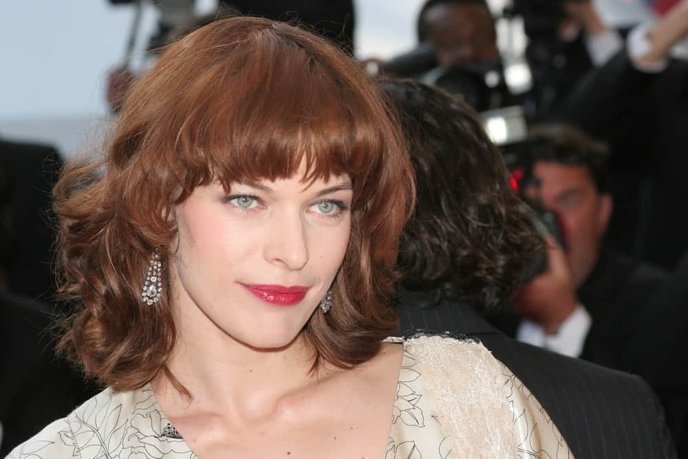 Milla Jovovich attended the screening of 'Three Burials of Melquiades Estrada' at the Grand Theatre during the 58th Cannes Film Festival on May 20, 2005 in Cannes, France. She was stunning in her beige dress and tousled shoulder-length hair with bangs and a reddish tone.