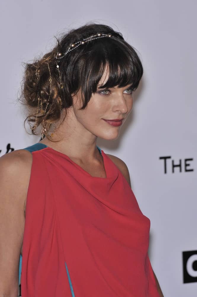 Milla Jovovich was at the 61st Annual Cannes Film Festival amfAR's Cinema Against AIDS 2008 Gala at Le Moulin de Mougins restaurant on May 22, 2008, in Cannes, France. She was stunning her fashionable pink dress and messy bun hairstyle with bangs.