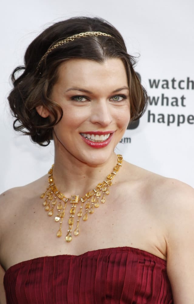 On May 4, 2009, in Los Angele, Milla Jovovich at the Bravo's 2nd Annual A-List Awards held at the Orpheum Theater in Los Angeles, California. She wore a red strapless dress with gold accessories and a gold headband for her tousled and curly chin-length hairstyle.