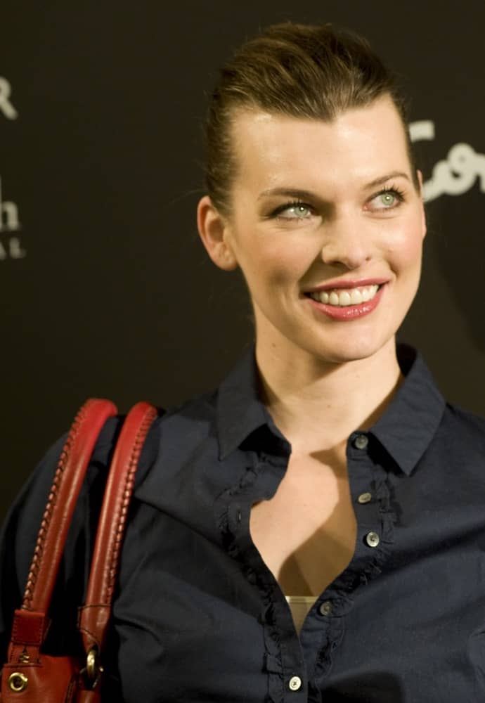 Milla Jovovich was at the presentation of the new Tommy Hilfiger complements collection on March 18, 2010 in Madrid. She was lovely in a dark outfit to pair with her slicked back neat hairstyle and simple makeup.