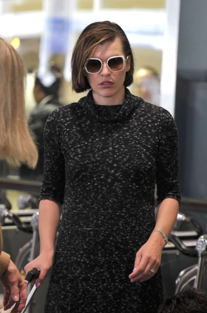 Actress Milla Jovovich was seen at the LAX airport on February 15, 2010 in Los Angeles, California. She was seen wearing a simple black dress to pair with her straight chin-length hairstyle with side-swept bangs.