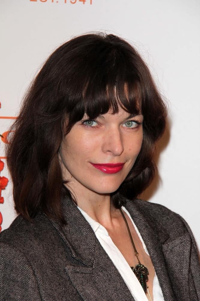 Milla Jovovich was at the Coach's 3rd Annual Evening of Cocktails and Shopping at the Bad Robot on April 10, 2013 in Santa Monica, CA. She went with a simple smart casual outfit to pair with her red lips and loose tousled brunette hairstyle with bangs and layers.