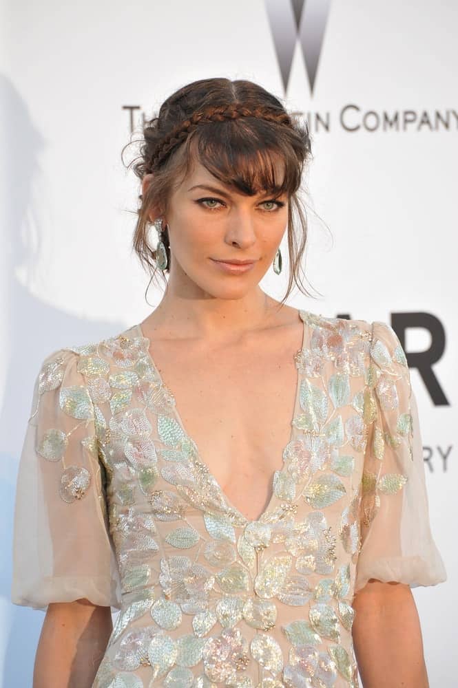Milla Jovovich was at the amfAR's 20th Cinema Against AIDS Gala at the Hotel du Cap d'Antibes, France on May 23, 2013, in Antibes, France. She was charming in a sheer white dress and her hair was incorporated with braids, bangs and loose tendrils in an upstyle.