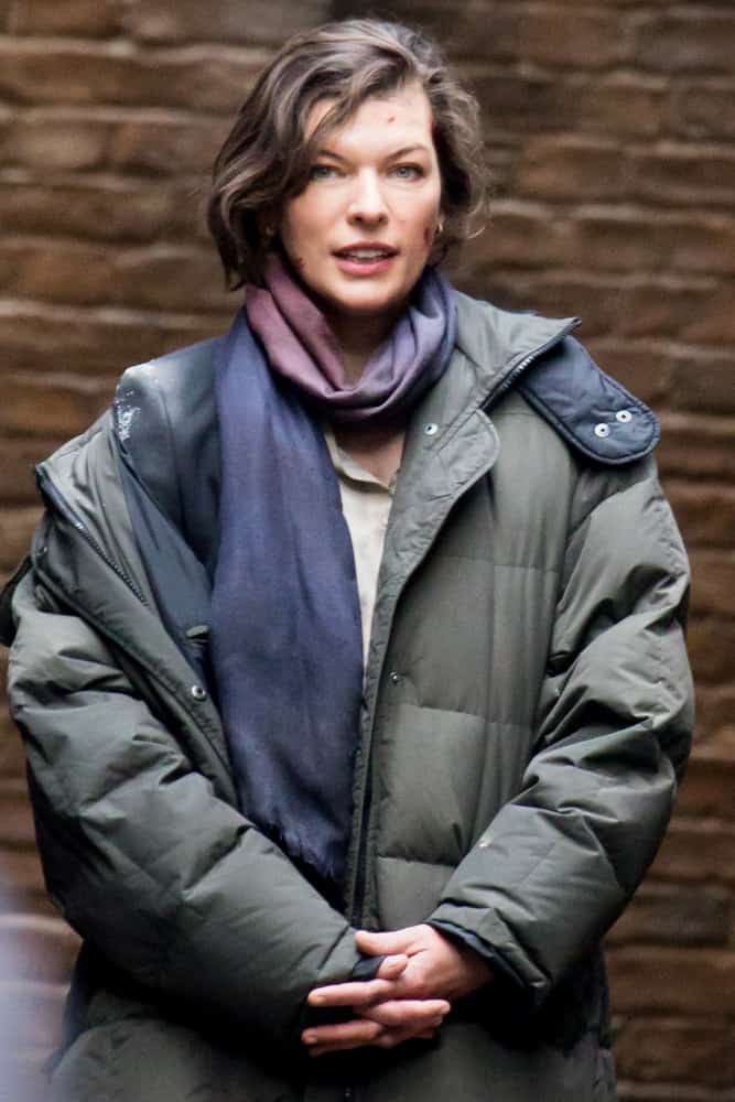 Milla Jovovich was spotted filming her latest movie in London on February 15, 2013 in London, UK. She was wearing a winter jacket with a scarf and her highlighted chin-length hair was side-swept and tousled.