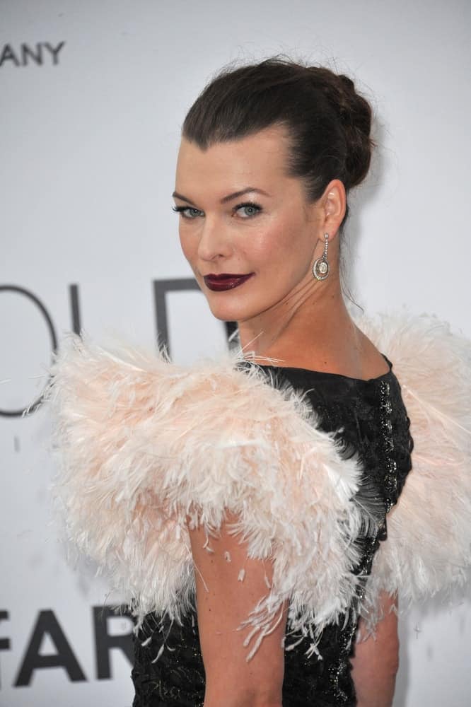 On May 22, 2014, Milla Jovovich was at the 21st annual amfAR Cinema Against AIDS Gala at the Hotel du Cap d'Antibes. She was stunning in her ruffled dress, dark lips and slicked back raven bun hairstyle.