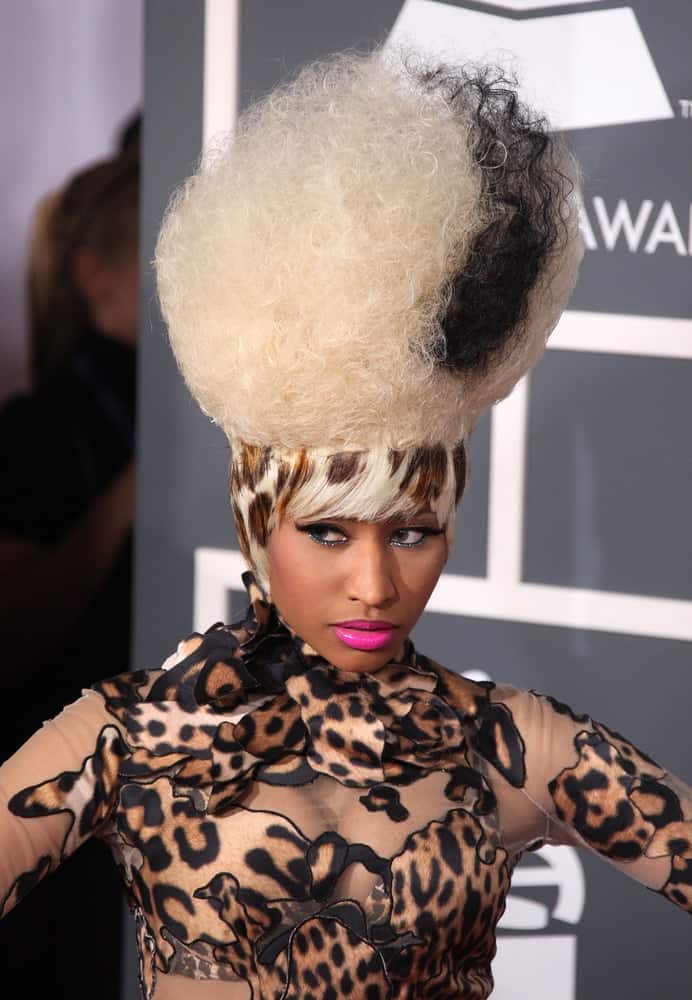 Nicki Minaj was at the 2011 Grammy Awards on February 13, 2011 in Los Angeles, CA. She wore an animal print sheer body suit to pair with her unique Frankenstein's bride beehive blond hairstyle dyed with black and animal print at the base.