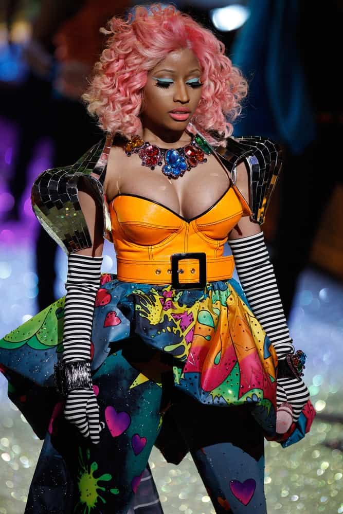 Nicki Minaj performed on the runway during the 2011 Victoria's Secret Fashion Show at the Lexington Avenue Armory on November 9, 2011 in New York City. She was seen with a colorful and artistic outfit with her pink-dyed curly shoulder-length hairstyle.