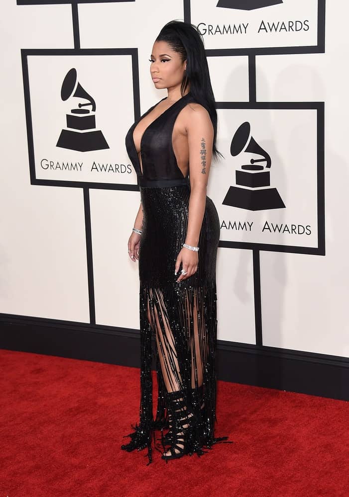 Nicki Minaj was in attendance at the Grammy Awards 2015 on February 8, 2015 in Los Angeles, CA. She came wearing an elegant and shiny black dress that she paired with a tousled and side-swept raven hairstyle.
