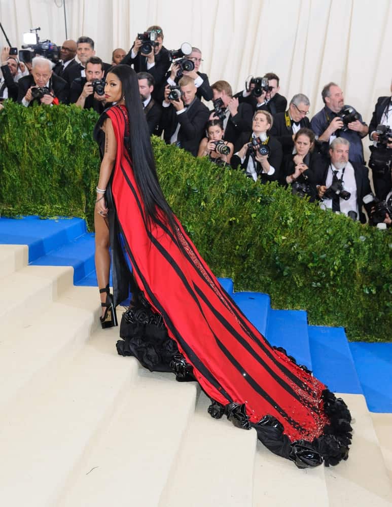 Nicki Minaj attended the 2017 Metropolitan Museum of Art Costume Institute Benefit Gala at The Metropolitan Museum of Art in New York, NY on May 1, 2017. She was seen wearing a long red gown that she paired with her very long and straight raven hair on her back.