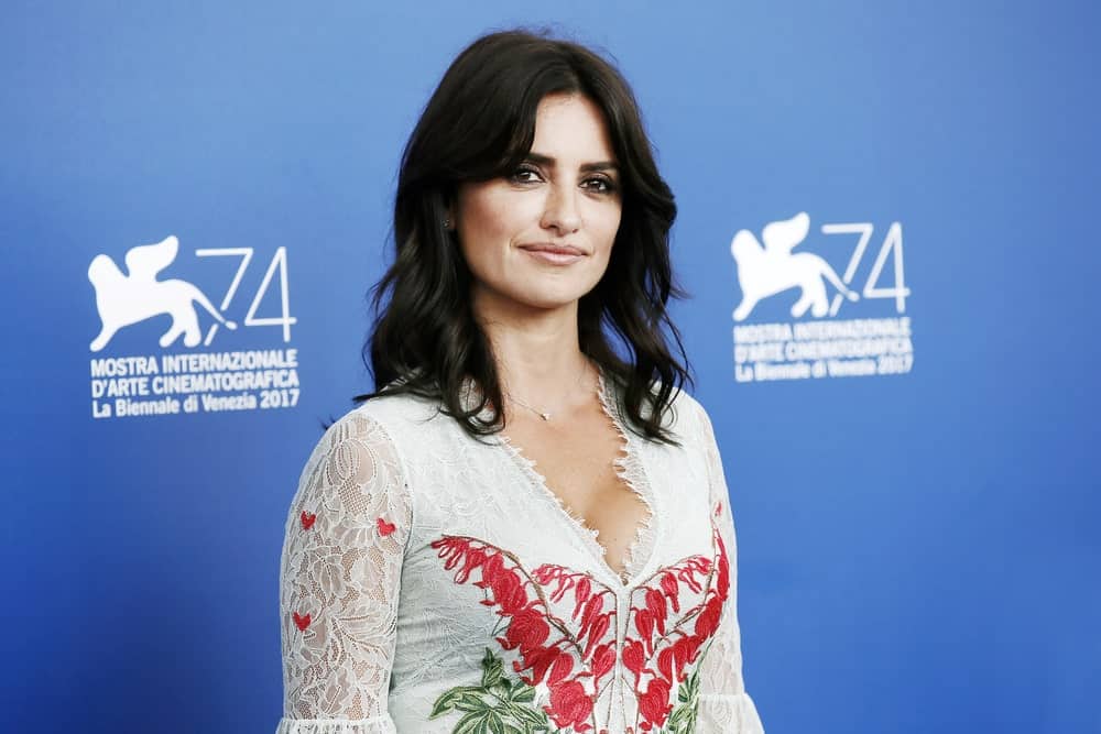 On September 6, 2017, Penelope Cruz attended the photo-call of the movie 'Loving Pablo' wearing a white lace dress and beach waves hairstyle.