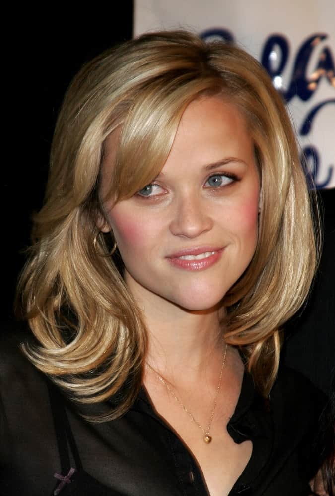 On October 6, 2005, Reese Witherspoon paired her simple black blouse with a tousled and layered shoulder-length blond hairstyle with side-swept bangs at the Children's Defense Fund's 15th Annual Los Angeles "Beat The Odds" Awards at the Beverly Hills Hotel in Beverly Hills, California USA.
