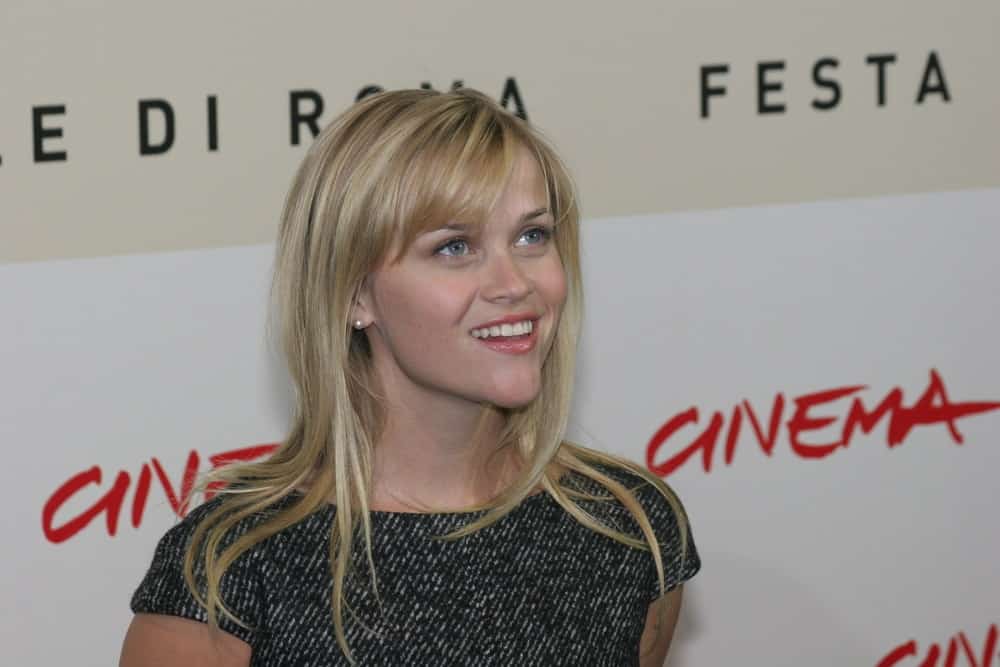 Actress Reese Witherspoon went with a simple look to her gray dress and loose, tousled and highlighted blond hairstyle with layers and bangs at the photocall for the movie 'Rendition' during day 4 of the 2nd Rome Film Festival on October 21, 2007 in Rome, Italy.
