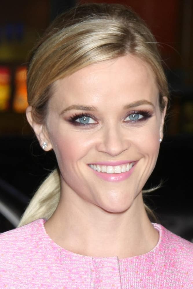 Reese Witherspoon wore a cute and charming pink short dress that she paired well with her simple make-up and low blond ponytail with highlights at the "Inherent Vice" Los Angeles Premiere at the TCL Chinese Theater on December 10, 2014 in Los Angeles, CA.