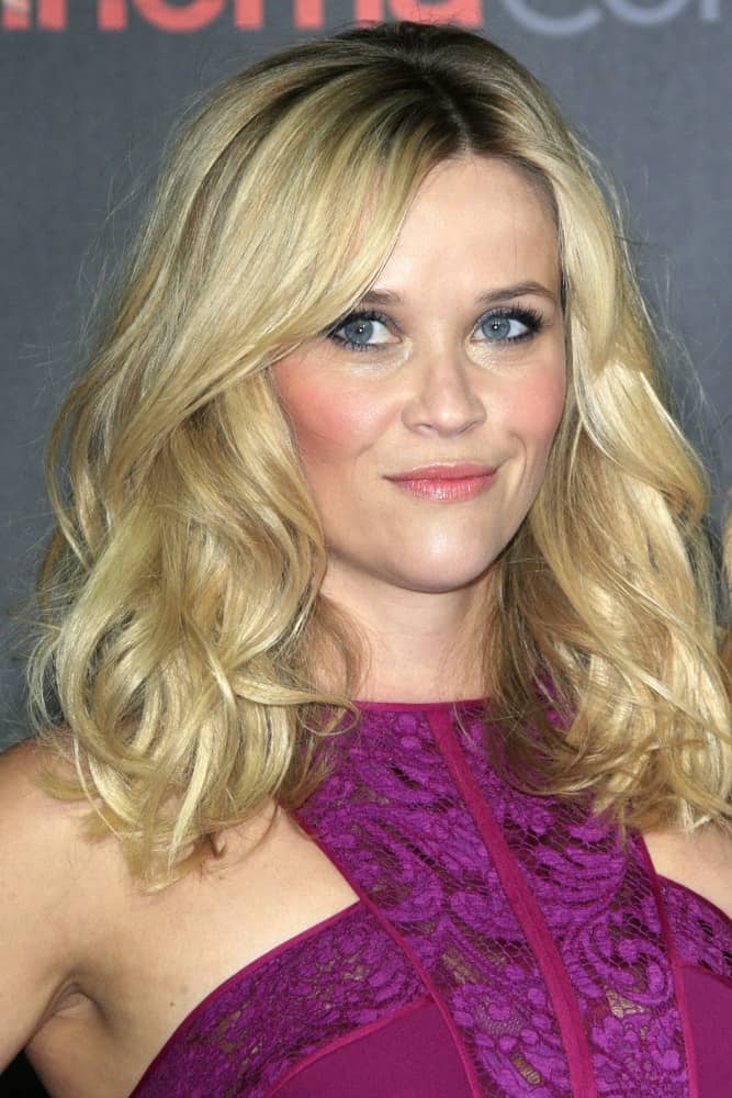 Reese Witherspoon attended the Warner Brothers 2015 Presentation at Cinemacon at the Caesars Palace on April 21, 2015 in Las Vegas CA. She wore a stunning purple dress with her tousled and wavy shoulder-length blond hairstyle with layers.