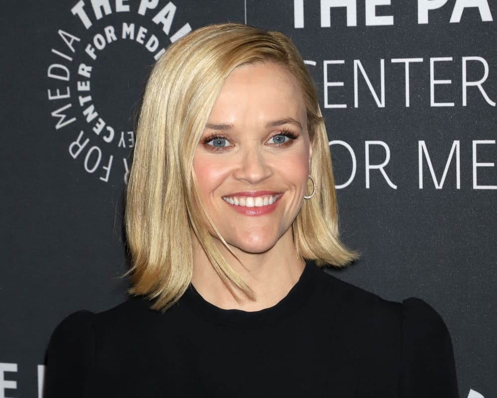 Reese Witherspoon attended the promotional event for "The Morning Show" on October 30, 2019, in New York. She wore a simple black dress that was complemented by her slick and straight side-parted blond bob hairstyle.