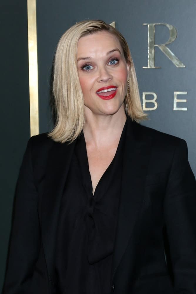Reese Witherspoon's slick and straight blond shoulder-length hair had a side-part and a flippy finish at the tips at the "Truth Be Told" Premiere Screening at Samuel Goldwyn Theater on November 11, 2019 in Beverly Hills, CA.