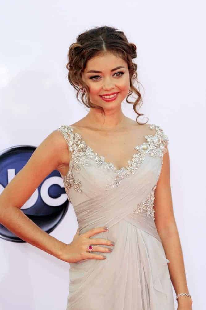 Sarah Hyland attended the 64th Primetime Emmy Awards held at Nokia Theater L.A. Live on September 23, 2012, in Los Angeles, California. She wore a sparkly dress that went well with her highlighted messy hair bun that has loose curly bangs and tendrils.