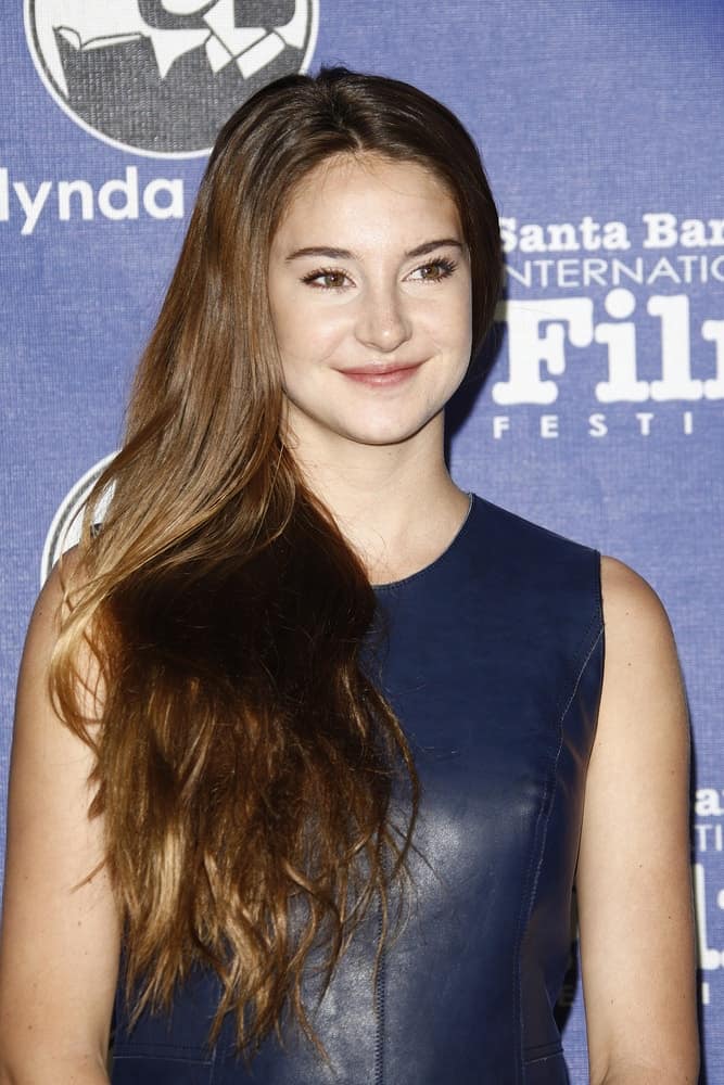 Shailene Woodley was at the 27th annual Santa Barbara Film Festival Virtuosos Award Ceremony at the Arlington Theater on February 3, 2012 in Santa Barbara, California. She was seen wearing a navy blue leather dress to pair with her side-swept long highlighted brunette hairstyle with layers.