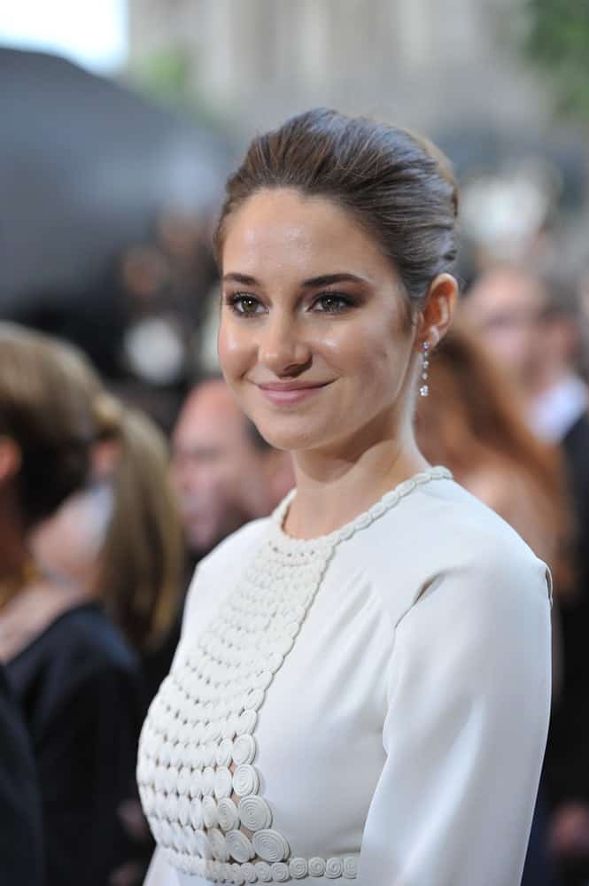 On February 26, 2012, Shailene Woodley attended the 84th Annual Academy Awards at the Hollywood & Highland Theatre, Hollywood. She wore an elegant white dress to pair with her slicked-back brunette bun hairstyle.
