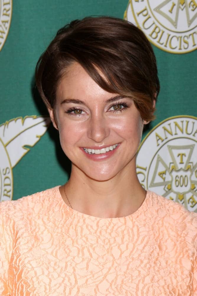 Shailene Woodley was at the 2014 Publicist Luncheon at Beverly Wilshire Hotel on February 28, 2014 in Beverly Hills, CA. She was charming in a peach dress to pair with her brunetter pixie hairstyle with side-swept bangs.