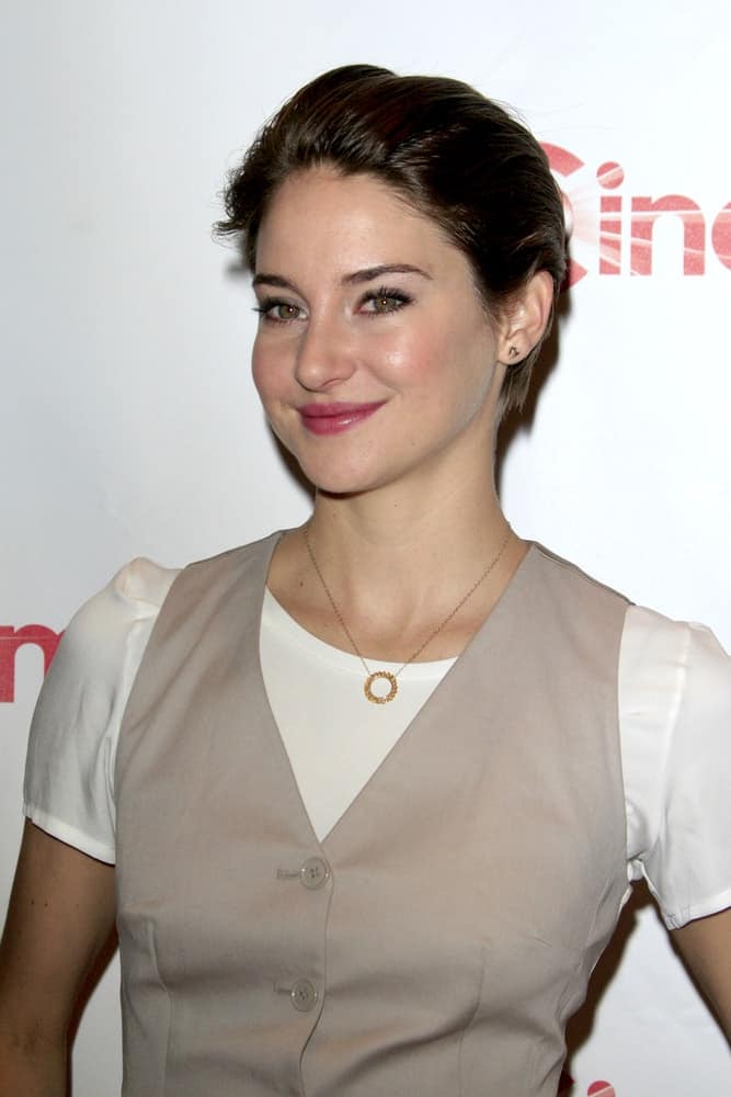 Shailene Woodley attended the 20th Century Fox CinemaCon 2014 Photo Call at Caesars Palace on March 27, 2014 in Las Vegas, NV. She wore a vest over her white blouse and paired it with a slicked-back raven pixie hairstyle.