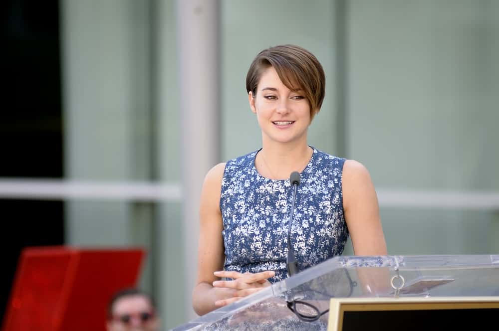 Shailene Woodley spoke at Kate Winslet's star receiving ceremony at Hollywood Blvd on March 17, 2014 in Los Angeles, CA. She wore a floral dress with her side-swept brunette pixie hairstyle.