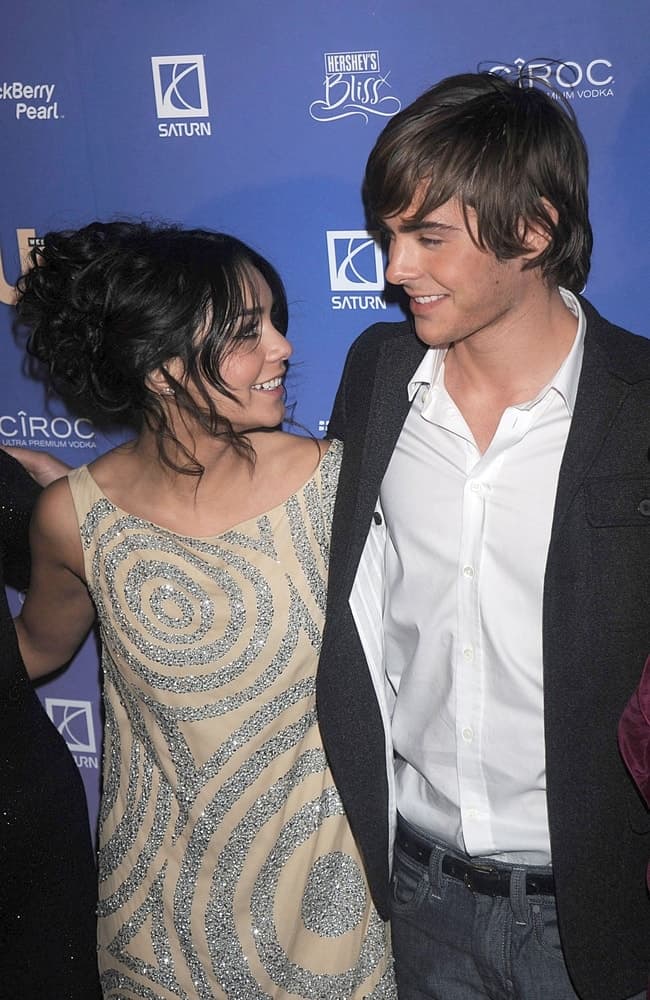 Vanessa Hudgens and Zac Efron were at the US WEEKLY Hot Hollywood Party at the Skylight in New York, NY on October 21, 2008. Hudgens wore an elegant silver glittery dress that paired quite well with her messy upstyle bun with loose curly hair and tendrils.