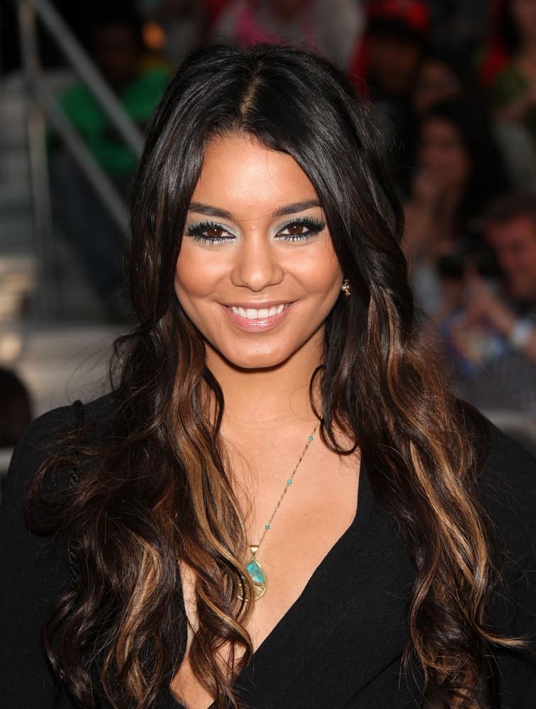 Vanessa Hudgens's simple black outfit was complemented by her lovely make-up and long, loose wavy hairstyle with brown highlights when she arrived at the "Pirates of the Caribbean: On Stranger Tides" World Premiere on May 7, 2011 in Anaheim, CA.